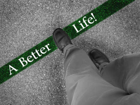 Man walking across a green line with words a better lifeの写真素材