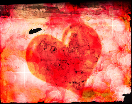 Valentines heart symbolizing giving love to another on old paperの写真素材