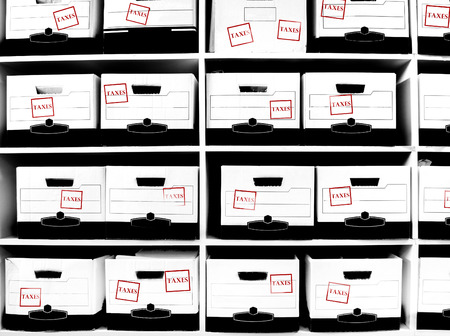Office shelves with boxes of tax documentsの写真素材