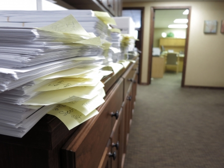 Messy office with many documents and disorganized tabsの写真素材