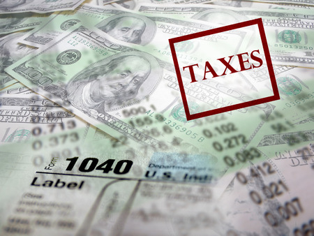 Detail closeup of current tax forms and pencil on money の写真素材
