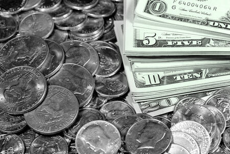Coins and dollar bills representing wealth and savings