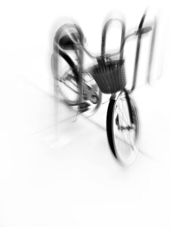 A single bike with basket in a bike rack in a city with zoom motionの写真素材