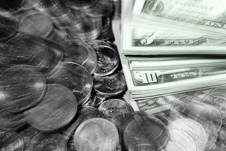 Coins and dollar bills representing wealth and savingsの写真素材