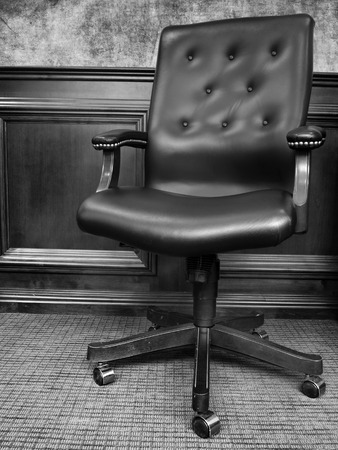 Black chair in business office with textured wallの写真素材