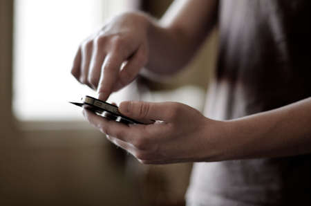 Person holding smart phone in hands to communicate and text