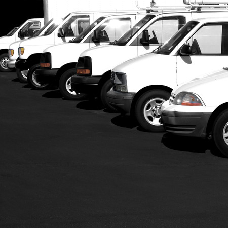 Several cars vans and trucks parked in parking lot for saleの写真素材