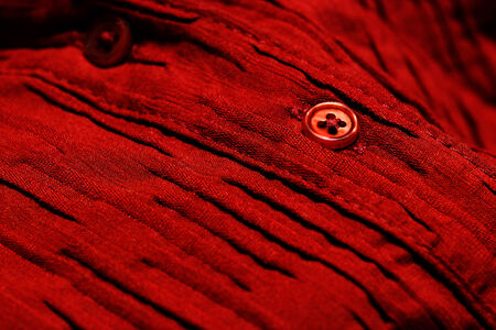 Detailed closeup macro of red button on red shirt