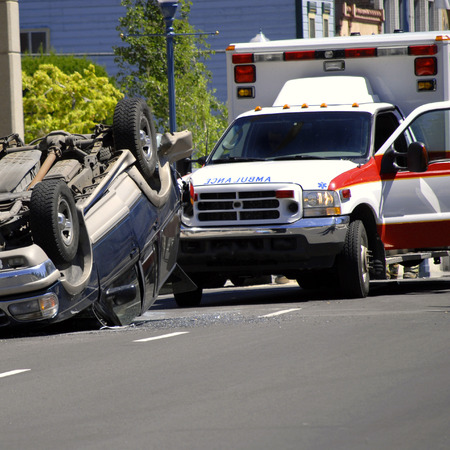 Car Wreck with Rolled Car Police and Ambulanceの写真素材