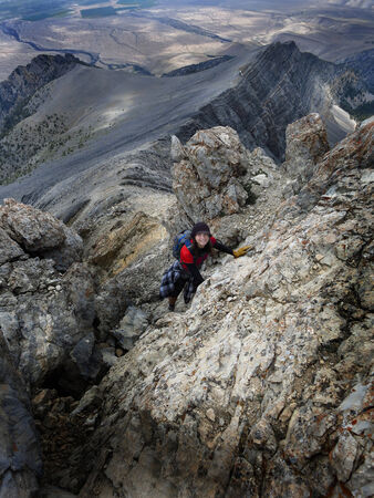 Girl hiker summit mountain top in triumph