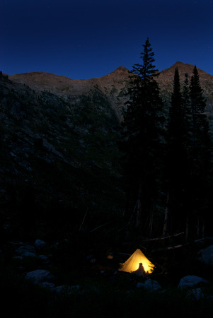 Detail of camping in glowing tent at night in mountainsの写真素材