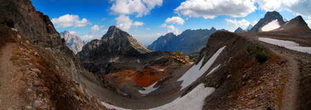 People  hiking on rugged mountainside in autumn