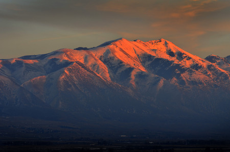 Landscape of tall mountain with glowing sunlight from sunset or sunrise