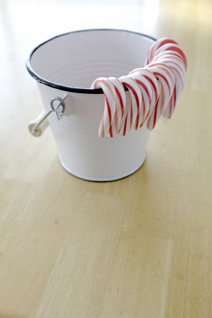 Closeup of isolated candy canes in a white bucketの写真素材