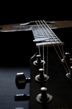 Closeup detail of guitar strings for playing music instrument talent strum strumming