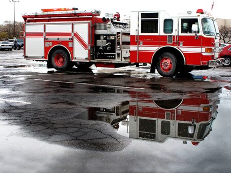 Red fire engine parked in street prepared for emergency