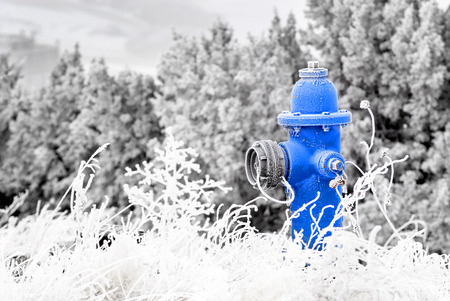 Winter Fire Hydrant with Snow and Frost Aroundの写真素材