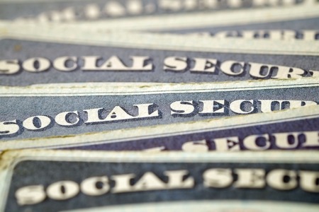 Closeup detail of several Social Security Cards representing finances and retirementの写真素材