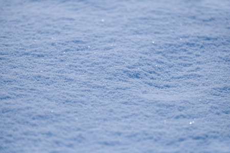 Freshly fallen snow on ground with ice crystals in winter frozen cold