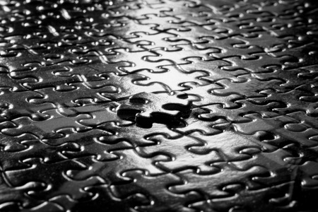 Table Surface with puzzle pieces on it showing successの写真素材