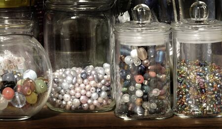 Beads in glass jars for creating art hobbies jewelryの写真素材