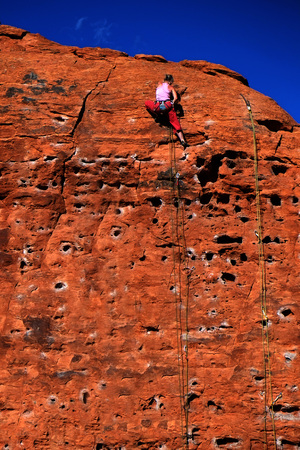 Rock climbing on red sandstone for sport recreation challenge and funの写真素材