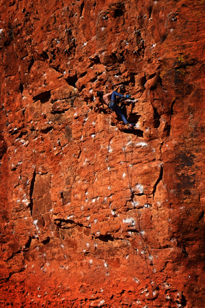 Rock climbing on red sandstone for sport recreation challenge and funの写真素材