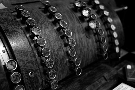 Detail of old fashioned vintage cash register with buttons for commerceの写真素材