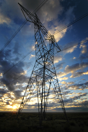 Landscape of power lines for electricity metal towers and sunsetの写真素材