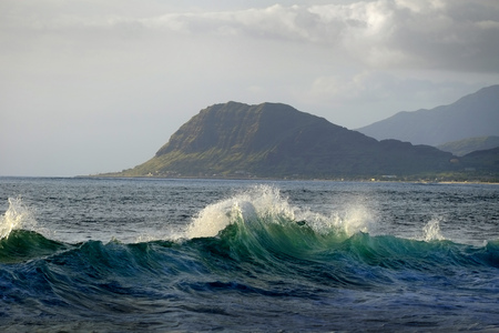 Mountains and ocean waves in skyの写真素材