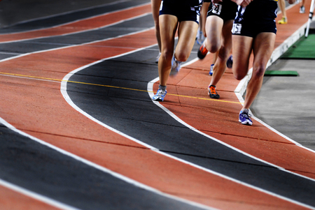 Running a race on a track for sports competition and winningの写真素材