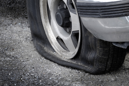Stranded with a flat tire on roadway car vehicle cannot moveの写真素材