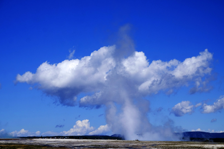 Large lanscape in Yellowstone National Park with steam rising and huge cloud people to give scaleの写真素材