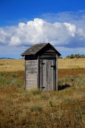 Old outhouse in prairie ghost town countryside abandoned historical areaの写真素材