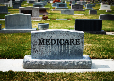 Medicare failure represented by cemetery gravestone markerの写真素材