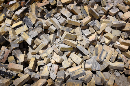 Pile of old bricks on ground in urban setting construction building tear down