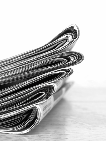 Stacks of newspapers providing news and updates to curent eventsの写真素材