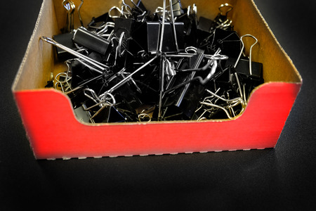 Box of binder clips binderclips office supplies of paperclips on deskの写真素材