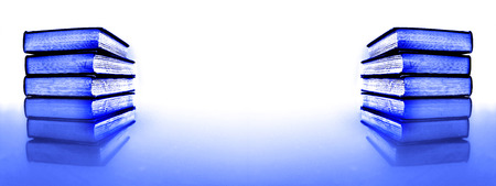 Stacks of books on a table for learning in school business law officeの写真素材