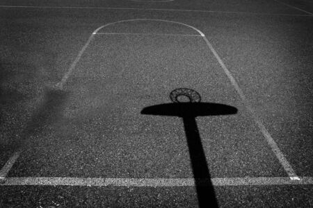 Urban basketball court with shadows on aspalt for sports competitionの写真素材