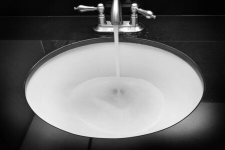 Bathroom sink with water flowing clean designの写真素材