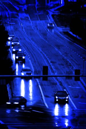 Driving in wet rainstorm traffic lights on roadの写真素材