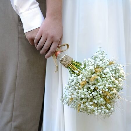 Bride and groom standing holding boquet marriage nuptials