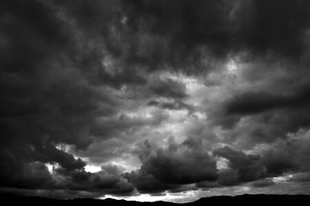 Dark stormy rain clouds over mountains fierce storm