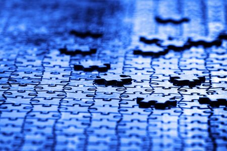 Puzzle pieces on table solving a game for fun and achievement jigsawの写真素材