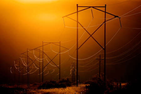 Powerlines reflecting light in valleyの写真素材