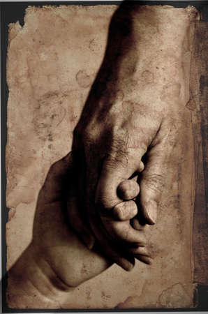Adult or parent holding the hand of a small child vintage old photography style original imageの写真素材