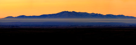 Sunrise with mountains and mist in the valley daybreak early dawn morningの写真素材