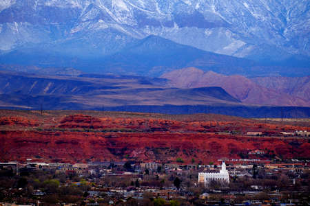 View of St. George Utah valley with Mormon LDS Temple red rocks and snow covered mountainsの写真素材