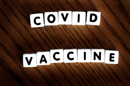 Covid Vaccine words block letters dice for cure from pandemicの写真素材